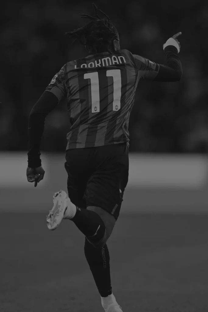 Ademola Lookman in Atalanta Bergamo kit celebrating a goal in front of Gewiss Stadium - represented by ROOF - Representatives of Outstanding Footballers.