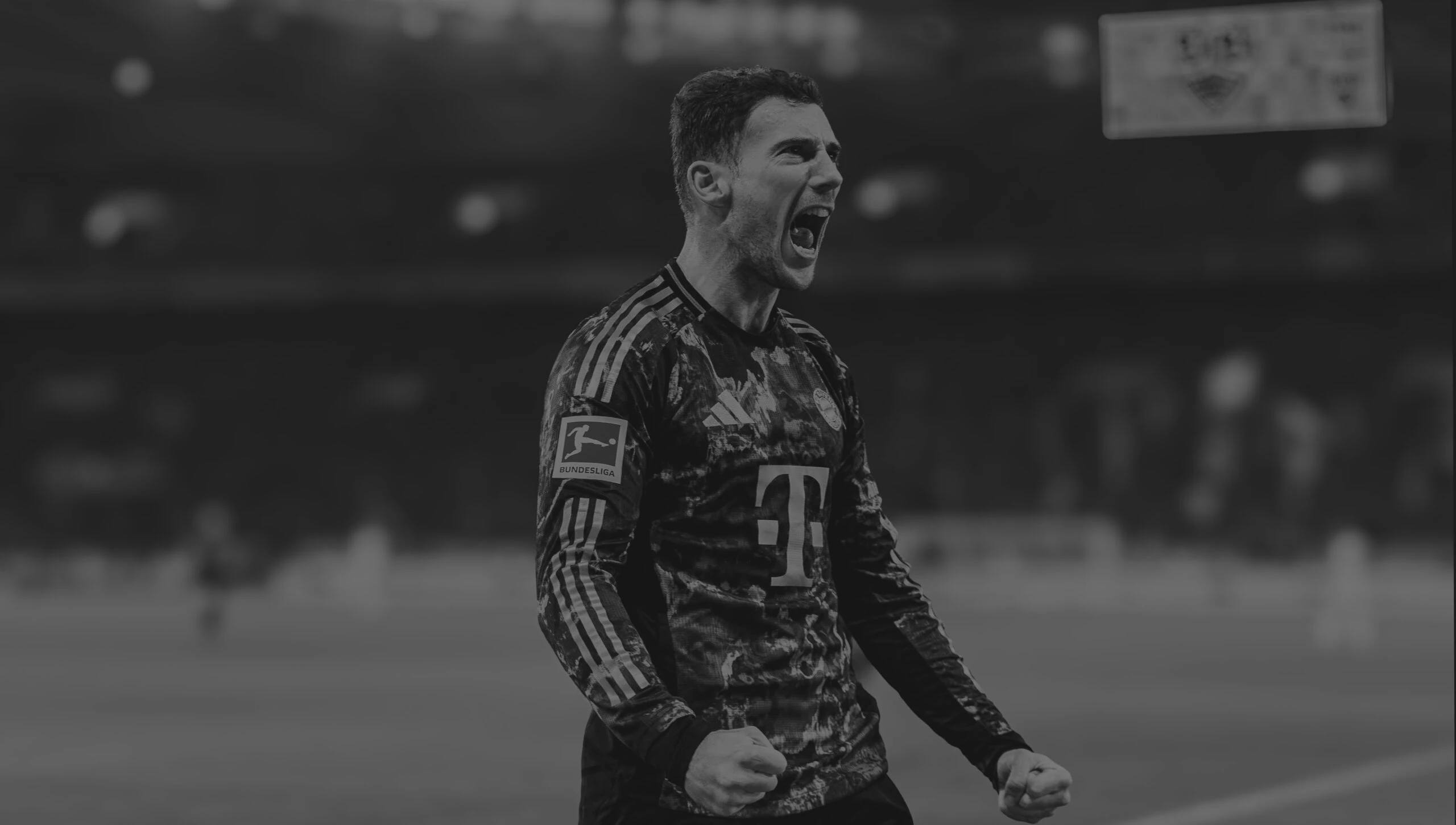 Leon Goretzka in FC Bayern Munich kit celebrating a goal in front of Allianz Arena - represented by ROOF - Representatives of Outstanding Footballers.