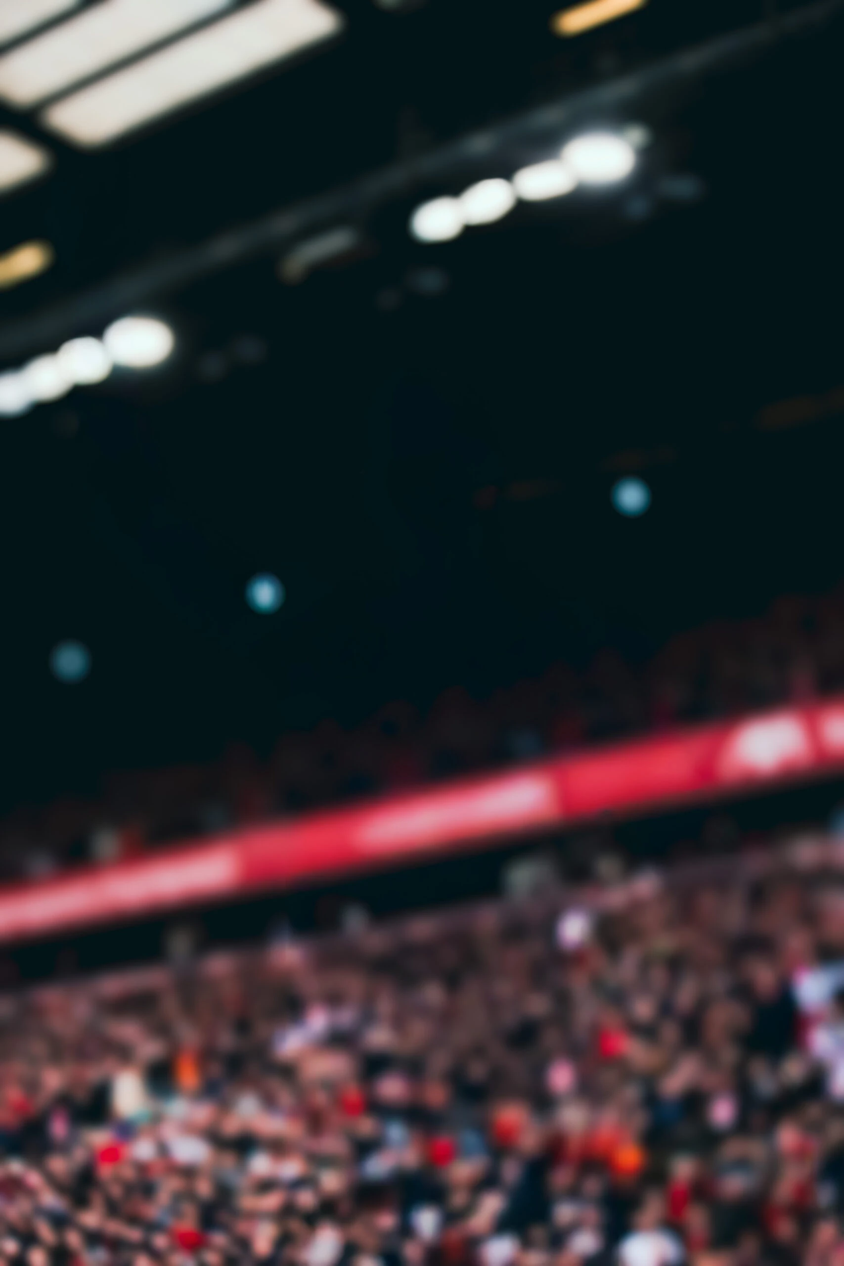 Virgil van Dijk in Liverpool FC kit standing in front of Anfield stadium - represented by ROOF Football Agency.